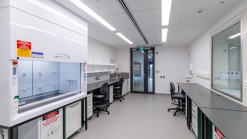 Bright lab interior at ACMD with fume hoods and workstations.