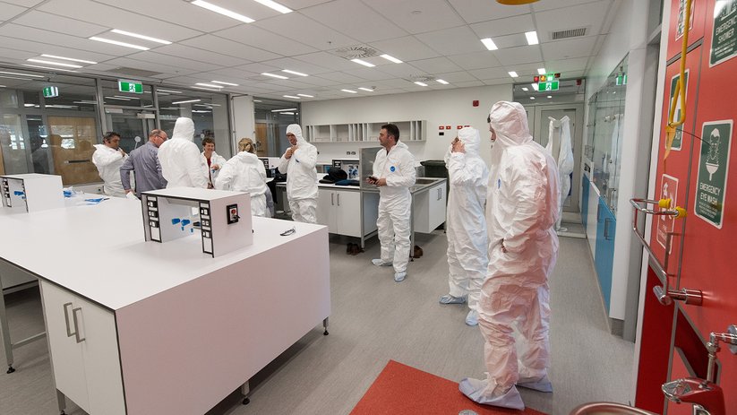 Cleanroom laboratory at the University of Otago with people in protective suits.