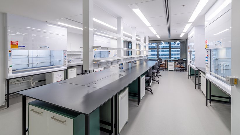 Minimal laboratory at ACMD with central bench and clean layout.