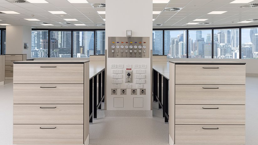 ymmetrical lab layout at CSL Melbourne with storage units and service panel.