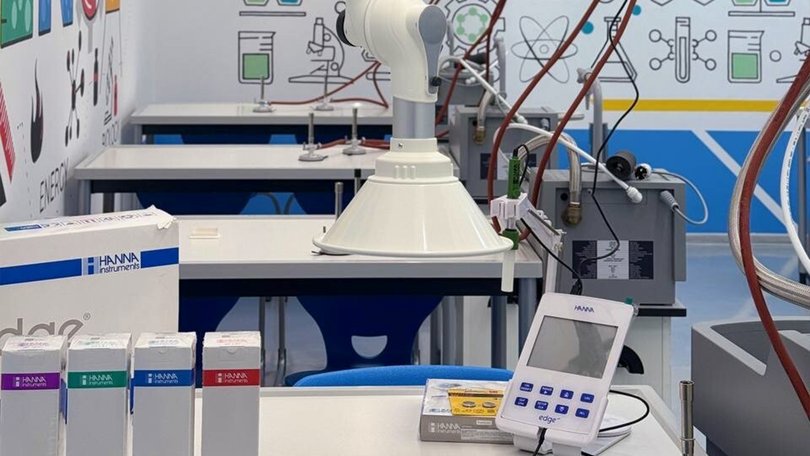 A modern laboratory workstation with fume cupboards and technical equipment