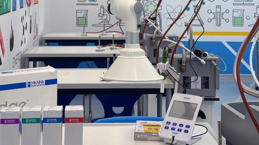 A modern laboratory workstation with fume cupboards and technical equipment