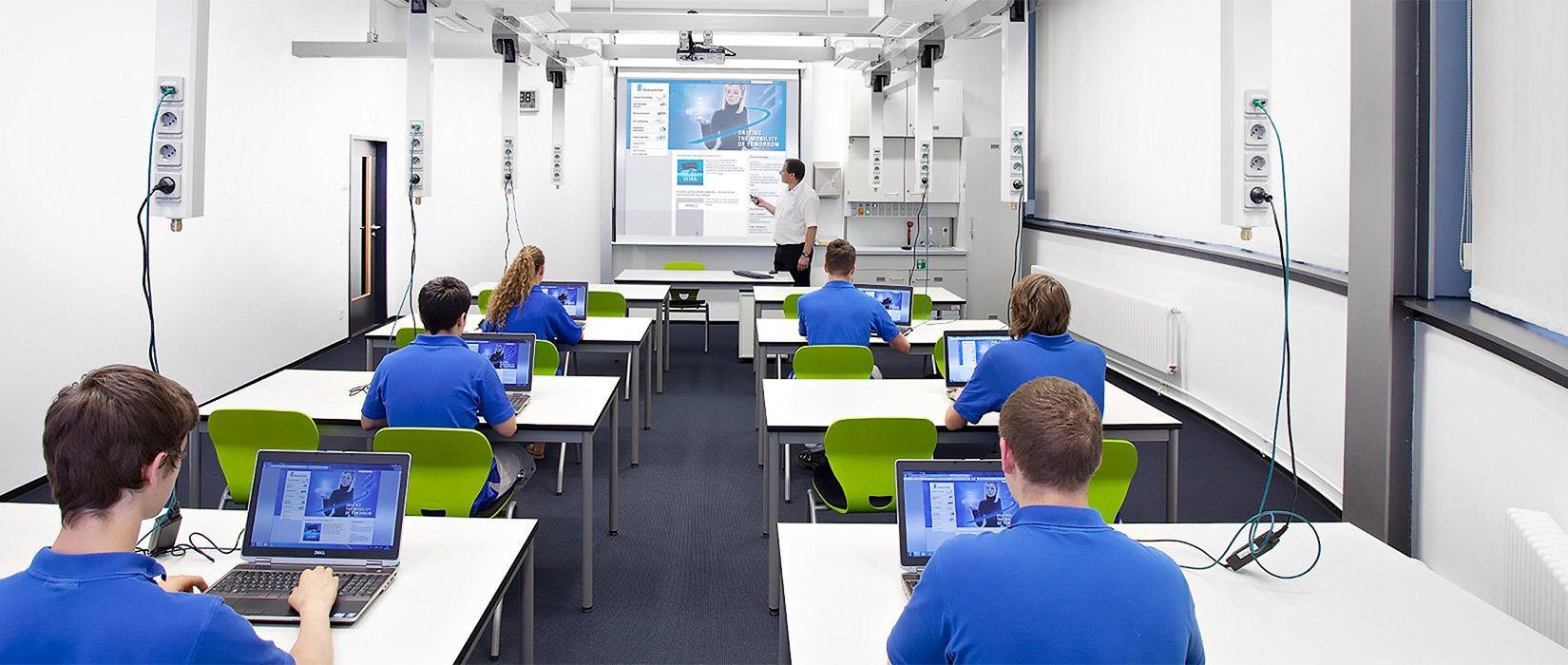 Students using laptops in classroom with Powerlift system