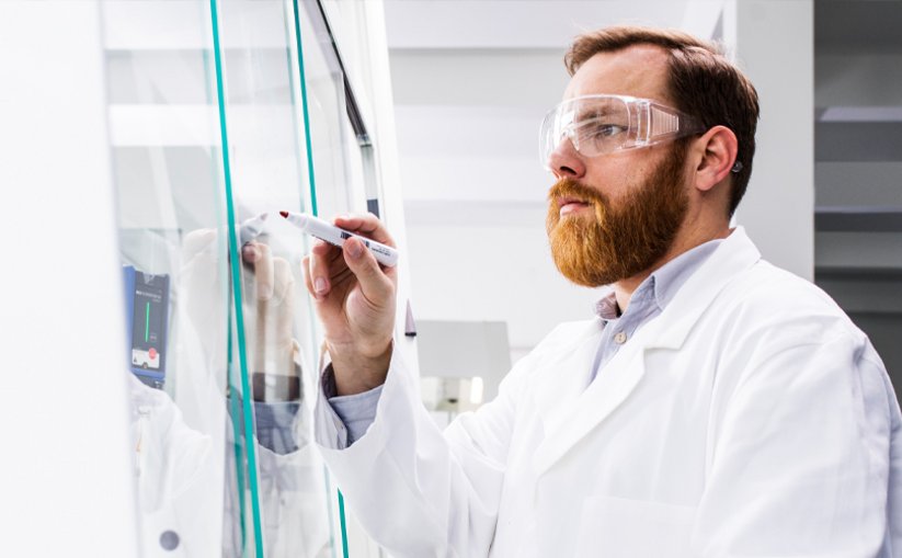 Laboratory worker in front of fume hood