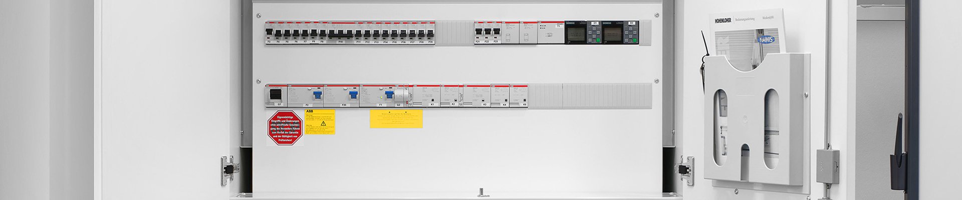 Electrical control cabinet with switches and safety labels