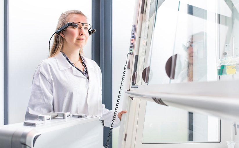 Laboratory technician operating with fume hood
