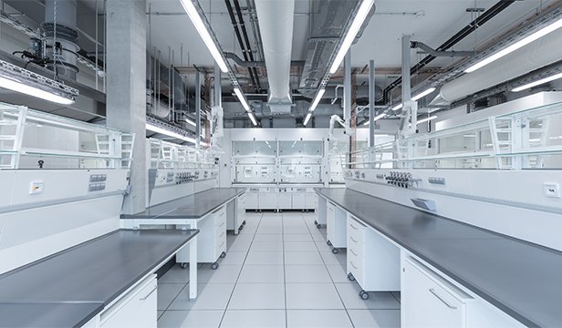 Row of modern laboratory benches in a large room