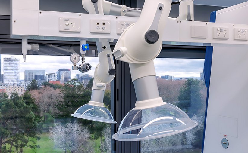 Two articulated local extraction arms mounted beneath overhead service panels