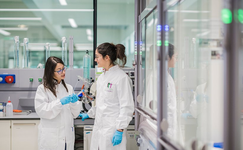 Two lab technicians in a conversation