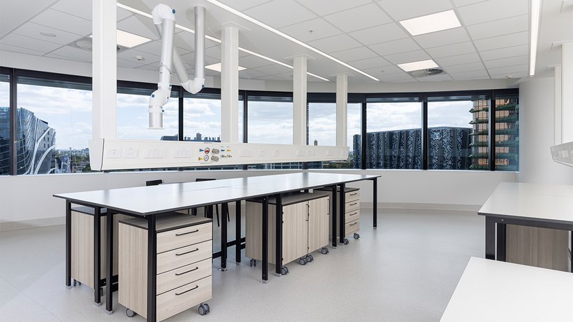Bright laboratory at CSL Melbourne with central workbench and ceiling services.