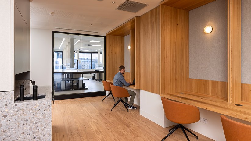 Quiet work area at CSL Melbourne with timber finishes and seating.