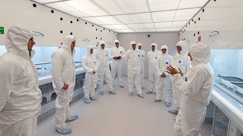 People meet in cleanroom at the University of Otago laboratory.